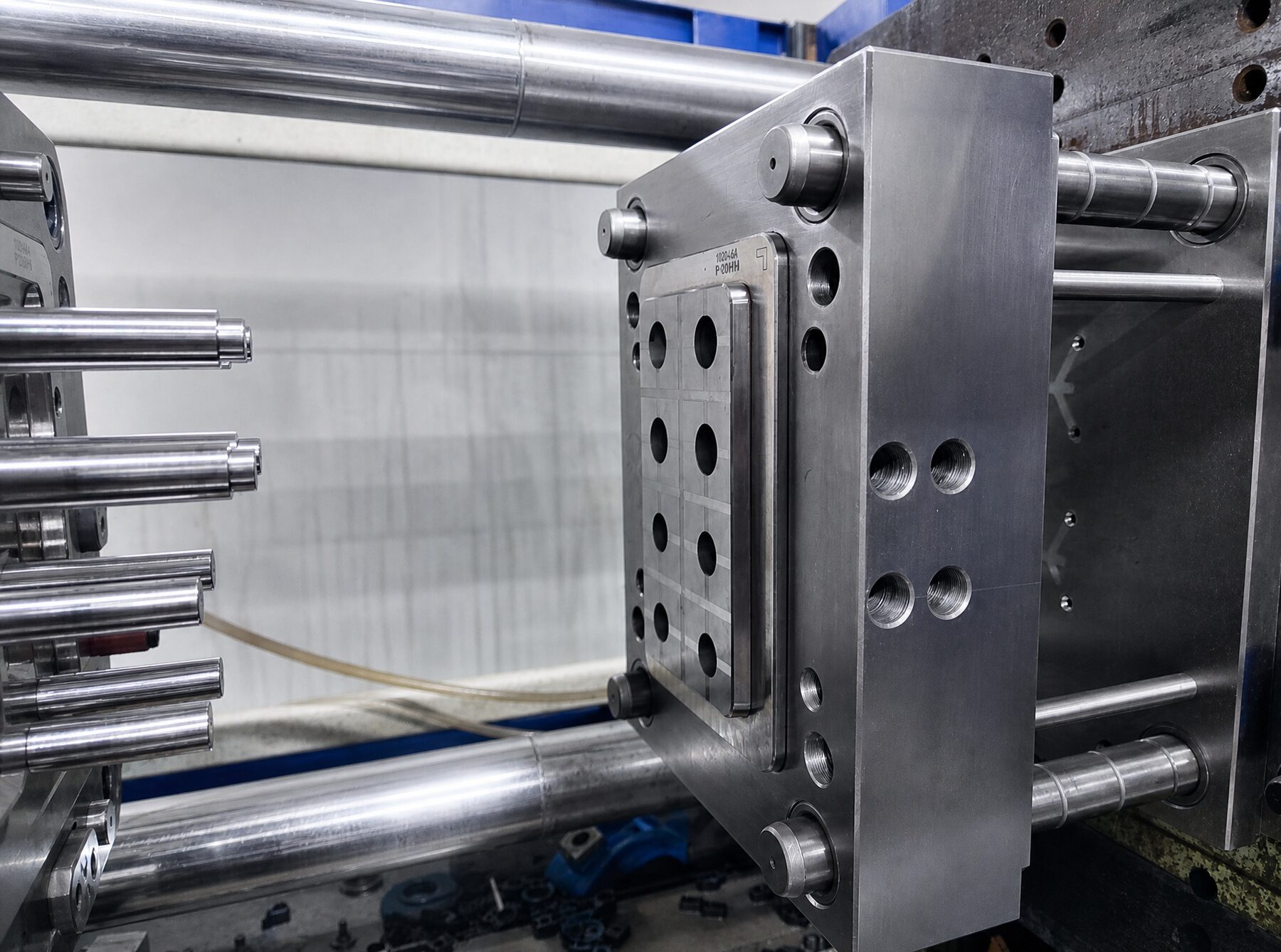 Open injection mold showing core pins and cooling